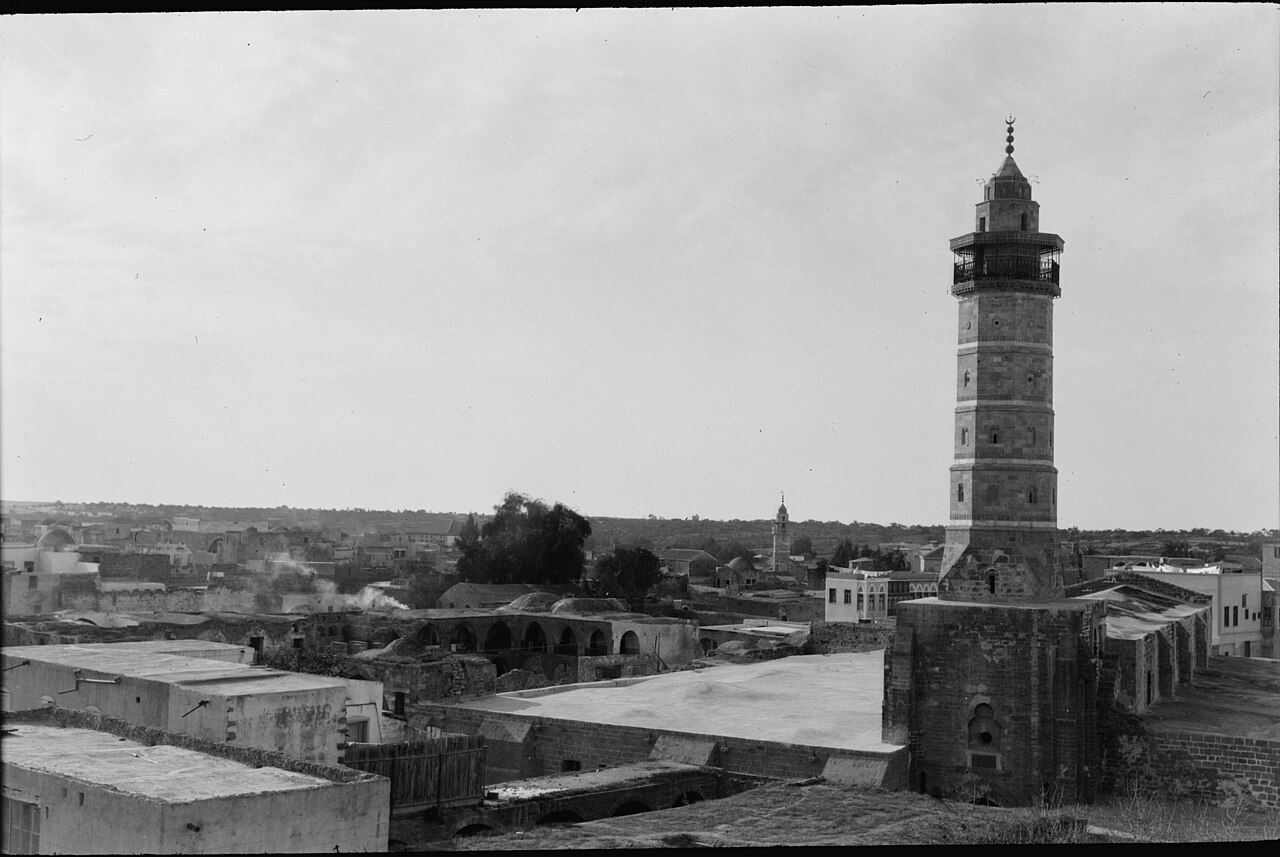 A historic photograph of a mosque and minaret in Gaza