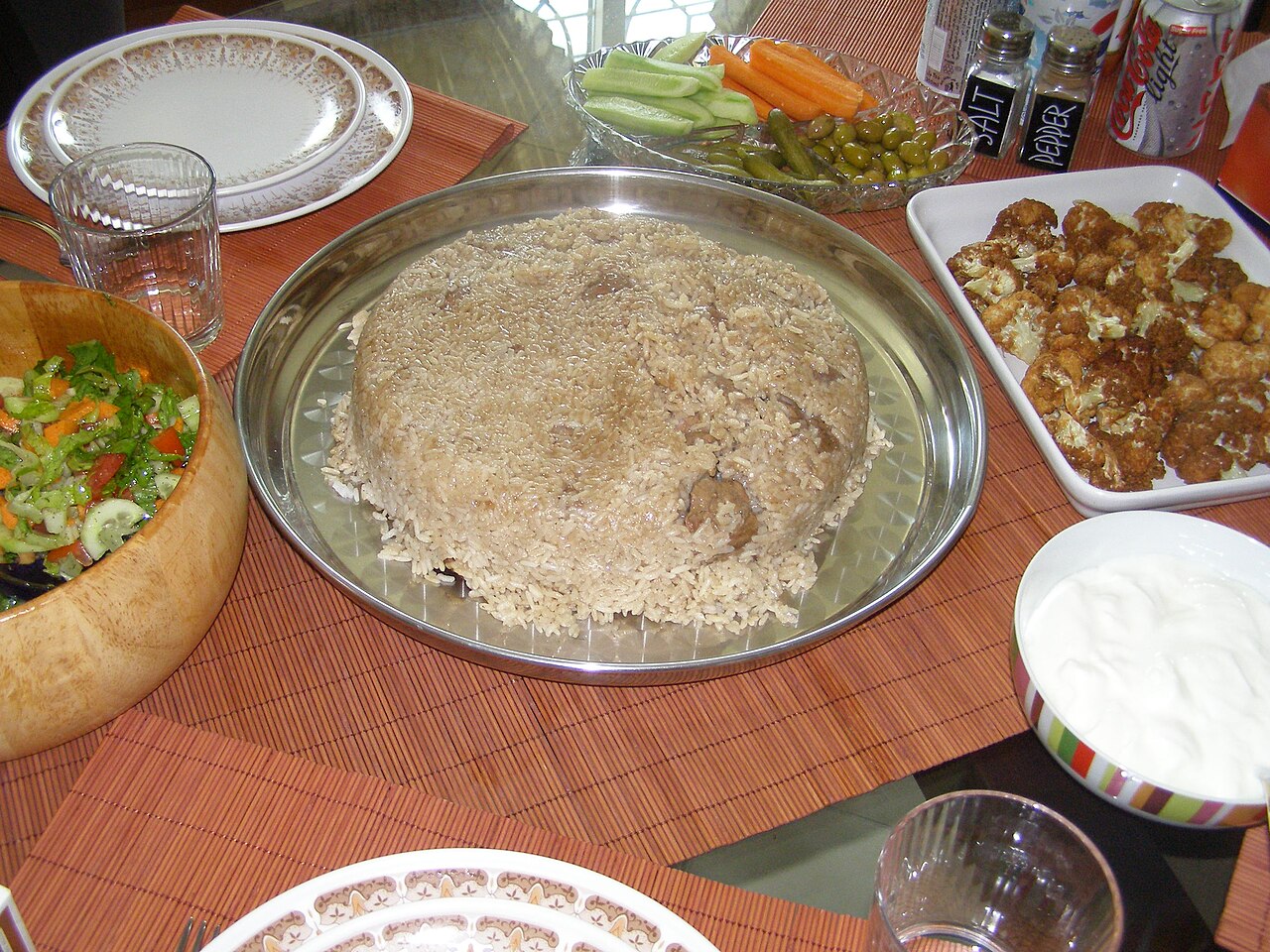 A tray of maqluba, rice moulded into a dome with eggplant